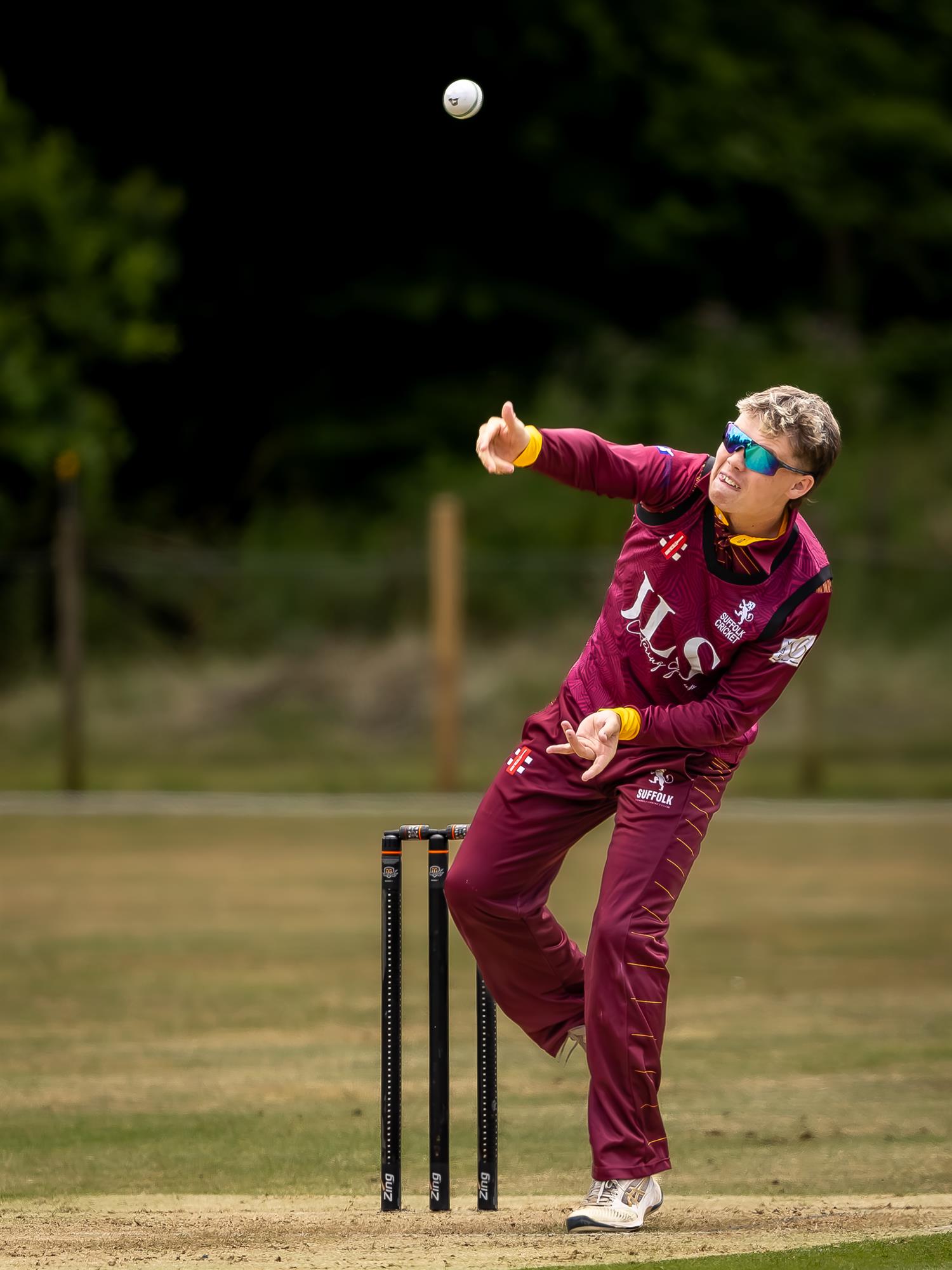 Ollie Burle bowling for Suffolk in the first of two NCCA Dojo T20 matches against Hertfordshire at Mellis Cricket Club on July 5th, 2026.