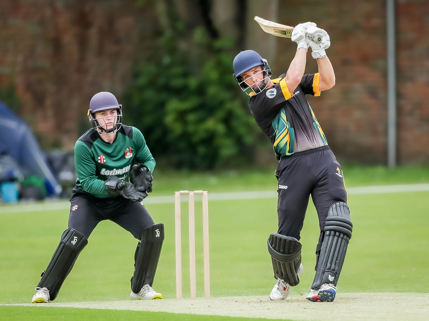 Lincolnshire's Ben Wright batting and Cumbria's Sam Bates keeping wicket in the NCCA Trophy match at Bourne Cricket Club on June 23rd, 2024.