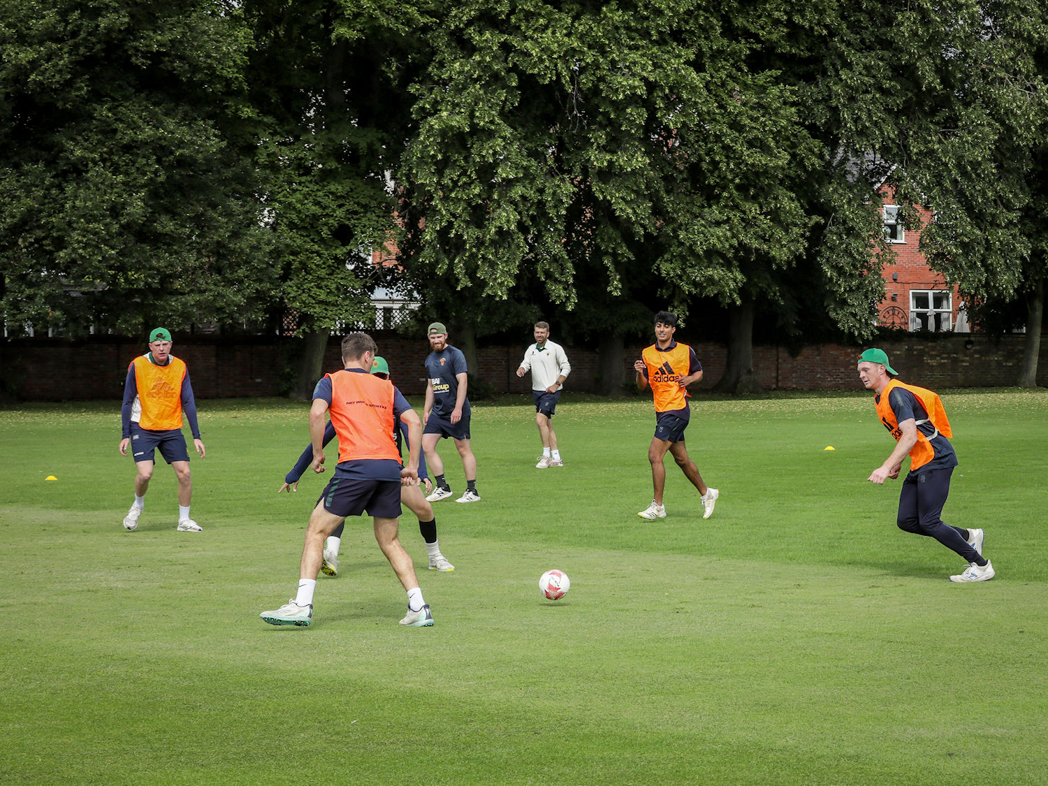 The Northumberland squad warm up with a game of football on the first day of the Durant Cricket National Counties Championship match against Bedfordshire at Bedford School on July 23rd, 2023.