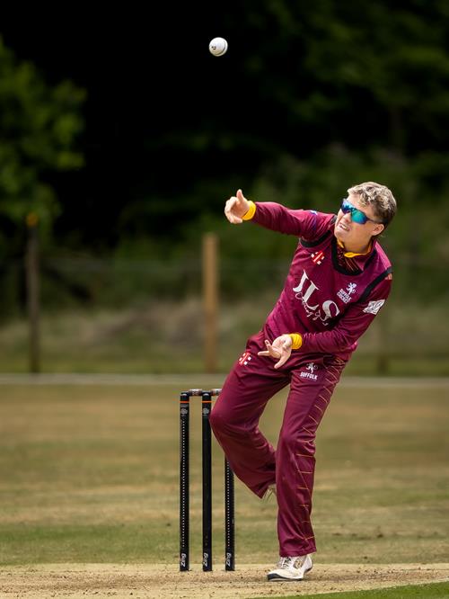 Ollie Burle bowling for Suffolk in the first of two NCCA Dojo T20 matches against Hertfordshire at Mellis Cricket Club on July 5th, 2026.