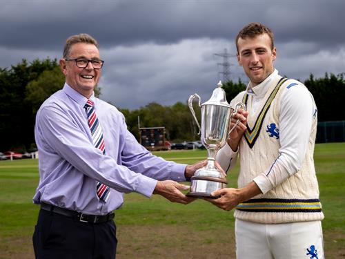 NCCA President Phil Caley presents the NCCA Cluberly Championship Trophy to Devon's captain James Horler following their victory in the Final against Buckinghamshire at West Bromwich Dartmouth Cricket Club.
