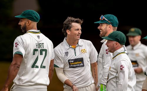 Staffordshire's Sam Keeling-Wright (centre) celebrates with team mates after taking the first of his eight wickets for 60 runs on the first day of the NCCA Cluberly Championship match against Cambridgeshire held at Checkley Cricket Club from July 26th–28th, 2026.