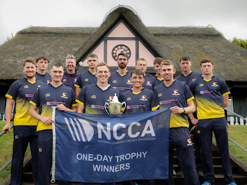 The victorious Norfolk squad with the NCCA Trophy in front of the pavilion at Wormsley Cricket Ground after their victory against Cheshire on August 25th, 2024.